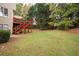 Spacious backyard featuring a two-story deck and lush green lawn with mature trees at 4651 Oakleigh Manor Dr, Powder Springs, GA 30127