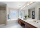 Bathroom with double sinks, jacuzzi tub, and patterned window at 4651 Oakleigh Manor Dr, Powder Springs, GA 30127