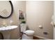 Cozy half-bathroom with pedestal sink and decorative accents at 4651 Oakleigh Manor Dr, Powder Springs, GA 30127