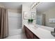 Bathroom with a shower-tub combo, single sink vanity, and large mirror at 4651 Oakleigh Manor Dr, Powder Springs, GA 30127