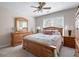 Cozy bedroom with neutral walls, ceiling fan, and coordinated wooden furniture at 4651 Oakleigh Manor Dr, Powder Springs, GA 30127