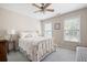 Well-lit bedroom features neutral colors and a large window at 4651 Oakleigh Manor Dr, Powder Springs, GA 30127