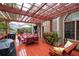 Covered wood deck with outdoor seating, pergola, hanging swing, and patio table at 4651 Oakleigh Manor Dr, Powder Springs, GA 30127