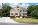 Charming two-story home with stone facade, black shutters, manicured lawn, and colorful landscaping at 4651 Oakleigh Manor Dr, Powder Springs, GA 30127