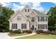 Inviting two-story home with stone accents, dark shutters, and a well-manicured lawn with a charming walkway at 4651 Oakleigh Manor Dr, Powder Springs, GA 30127