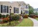 Charming home exterior showcasing a well-manicured front yard with lush flower beds at 4651 Oakleigh Manor Dr, Powder Springs, GA 30127