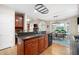 Open-concept kitchen with dark wood cabinetry, granite countertops, and a clear view into the breakfast nook and living spaces at 4651 Oakleigh Manor Dr, Powder Springs, GA 30127