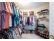 Spacious walk-in closet features organized shelving for clothing, shoes, and accessories at 4651 Oakleigh Manor Dr, Powder Springs, GA 30127