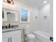 Bathroom with white tiled shower, granite vanity, and updated fixtures at 5068 Maple Dr, Forest Park, GA 30297