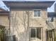 Back of the property features sliding doors, neutral siding, and partial fence at 5808 Trent Walk Dr, Lithonia, GA 30038
