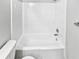 A white tiled shower and tub combination with chrome shower head and faucet at 5808 Trent Walk Dr, Lithonia, GA 30038