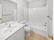 Clean bathroom with a shower-tub combo, single sink vanity, and neutral tile flooring at 5808 Trent Walk Dr, Lithonia, GA 30038