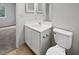 Clean bathroom featuring a white vanity, toilet, and a mirrored cabinet at 5808 Trent Walk Dr, Lithonia, GA 30038