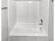A white tiled shower and tub combination with chrome shower head and faucet at 5808 Trent Walk Dr, Lithonia, GA 30038