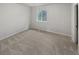Cozy carpeted bedroom with a window offering peaceful outdoor views at 5808 Trent Walk Dr, Lithonia, GA 30038