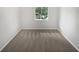 Bright bedroom featuring neutral carpet, fresh white walls, and a window offering natural light at 5808 Trent Walk Dr, Lithonia, GA 30038