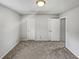 Bright bedroom featuring neutral walls, plush carpeting, and white doors at 5808 Trent Walk Dr, Lithonia, GA 30038