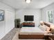 A cozy bedroom featuring a large window, ample closet space and neutral tones at 5808 Trent Walk Dr, Lithonia, GA 30038