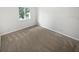 Carpeted bedroom featuring a window allowing natural light to illuminate the space at 5808 Trent Walk Dr, Lithonia, GA 30038