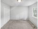 An empty bedroom featuring a large window, ample closet space and neutral tones at 5808 Trent Walk Dr, Lithonia, GA 30038