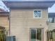 Back exterior view of a townhome with cedar siding and a sliding glass door at 5808 Trent Walk Dr, Lithonia, GA 30038