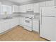 Efficient kitchen features white appliances, ample counter space, and tile flooring at 5808 Trent Walk Dr, Lithonia, GA 30038