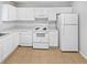 Well-lit kitchen featuring white appliances, countertops, and tile flooring at 5808 Trent Walk Dr, Lithonia, GA 30038