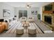 Bright living room with stone fireplace, ceiling fan, and sliding glass doors to the yard at 5808 Trent Walk Dr, Lithonia, GA 30038