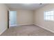 Bedroom with carpeting, natural light and doorway to hallway at 6557 Snow Bird Ln, Douglasville, GA 30134
