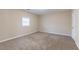 Large bedroom featuring a window and neutral carpeting at 6557 Snow Bird Ln, Douglasville, GA 30134