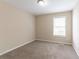 Cozy bedroom with neutral walls and carpet, a bright window, and ample space for furnishings at 6557 Snow Bird Ln, Douglasville, GA 30134