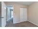 Bedroom with closet, doorway to hallway, and carpet at 6557 Snow Bird Ln, Douglasville, GA 30134