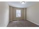 Bedroom featuring neutral walls and carpet, window with blinds, and ample space for furniture at 6557 Snow Bird Ln, Douglasville, GA 30134