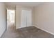 Spacious bedroom featuring neutral carpet and walls, and a large closet with bi-fold doors at 6557 Snow Bird Ln, Douglasville, GA 30134