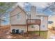 Two-story home featuring a wooden deck and beige siding at 6557 Snow Bird Ln, Douglasville, GA 30134