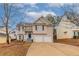 Charming home with a two-car garage, inviting front porch, and well-maintained landscaping at 6557 Snow Bird Ln, Douglasville, GA 30134