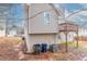 Rear exterior view of a home with vinyl siding, a wooden deck, and trash and recycling bins at 6557 Snow Bird Ln, Douglasville, GA 30134