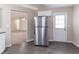 Open kitchen featuring stainless steel appliances, vinyl flooring, and adjacent living area at 6557 Snow Bird Ln, Douglasville, GA 30134