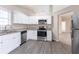 Bright kitchen featuring stainless steel appliances, granite counters, and vinyl plank flooring at 6557 Snow Bird Ln, Douglasville, GA 30134