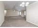 Spacious living room with neutral carpet, and access to the kitchen, dining and front entry at 6557 Snow Bird Ln, Douglasville, GA 30134