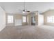 Spacious living room with neutral carpet, and access to the kitchen in a move-in ready home at 6557 Snow Bird Ln, Douglasville, GA 30134