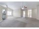 Vast living room with natural light, neutral carpet, and access to kitchen and bedrooms at 6557 Snow Bird Ln, Douglasville, GA 30134