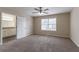 The main bedroom boasts neutral walls and carpet, plus an en suite bathroom with great natural light at 6557 Snow Bird Ln, Douglasville, GA 30134