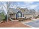 Charming townhome with a two-car garage, landscaped yard, and a mix of blue and brown siding at 1675 Water Vista Ct # 4501, Cumming, GA 30041