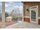 View from a concrete patio, featuring brick accents and a glimpse of a tranquil pond at 1675 Water Vista Ct # 4501, Cumming, GA 30041