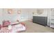 Cozy bedroom with two twin beds, a gray dresser, and cheerful decor at 2713 Serena Way, South Fulton, GA 30331