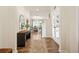 Inviting foyer featuring hardwood floors, a stylish mirror, and an open view to the living spaces at 2713 Serena Way, South Fulton, GA 30331
