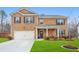 Inviting two-story brick home with a well-manicured lawn and attached two-car garage at 2713 Serena Way, South Fulton, GA 30331