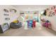 Bright playroom with a large carpet, lots of toys, and a TV at 2713 Serena Way, South Fulton, GA 30331