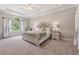 Serene main bedroom with trey ceiling, decorative bedding, and natural light from a large window at 4200 E 166 Hwy, Carrollton, GA 30116